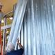 Workers put up shutters at a strip mall in Miami. Image: AP